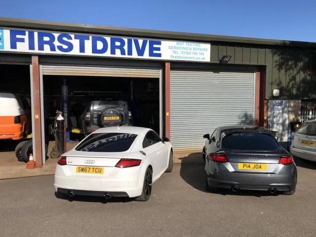 The Firstdrive garage with an Audi TT and a grey Audi outside