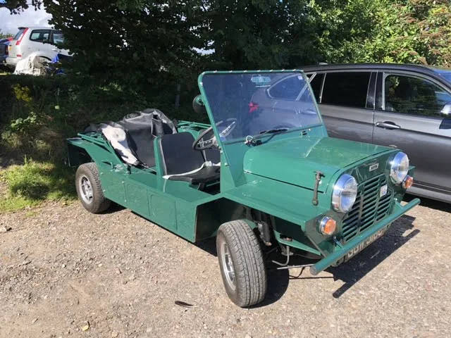 A green Mini Moke